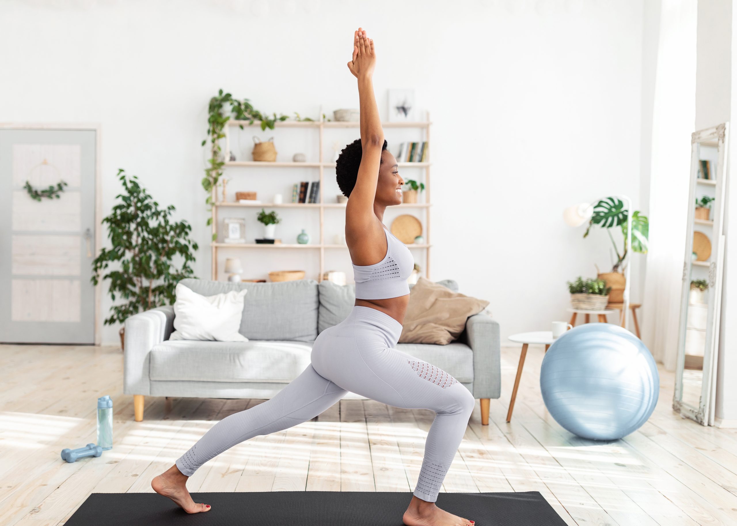 woman doing a yoga strength exercise at home