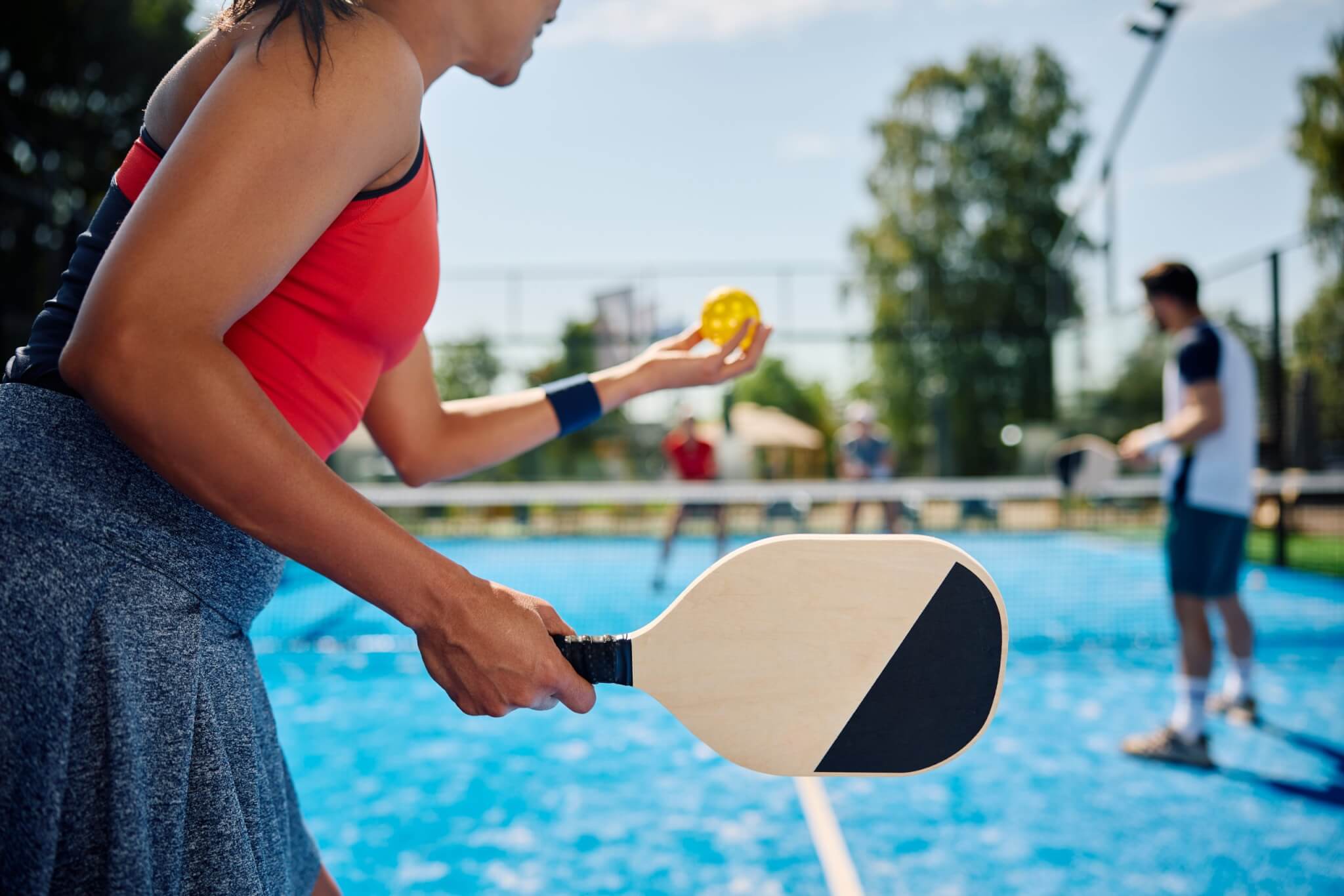group of women playing pickleball outside